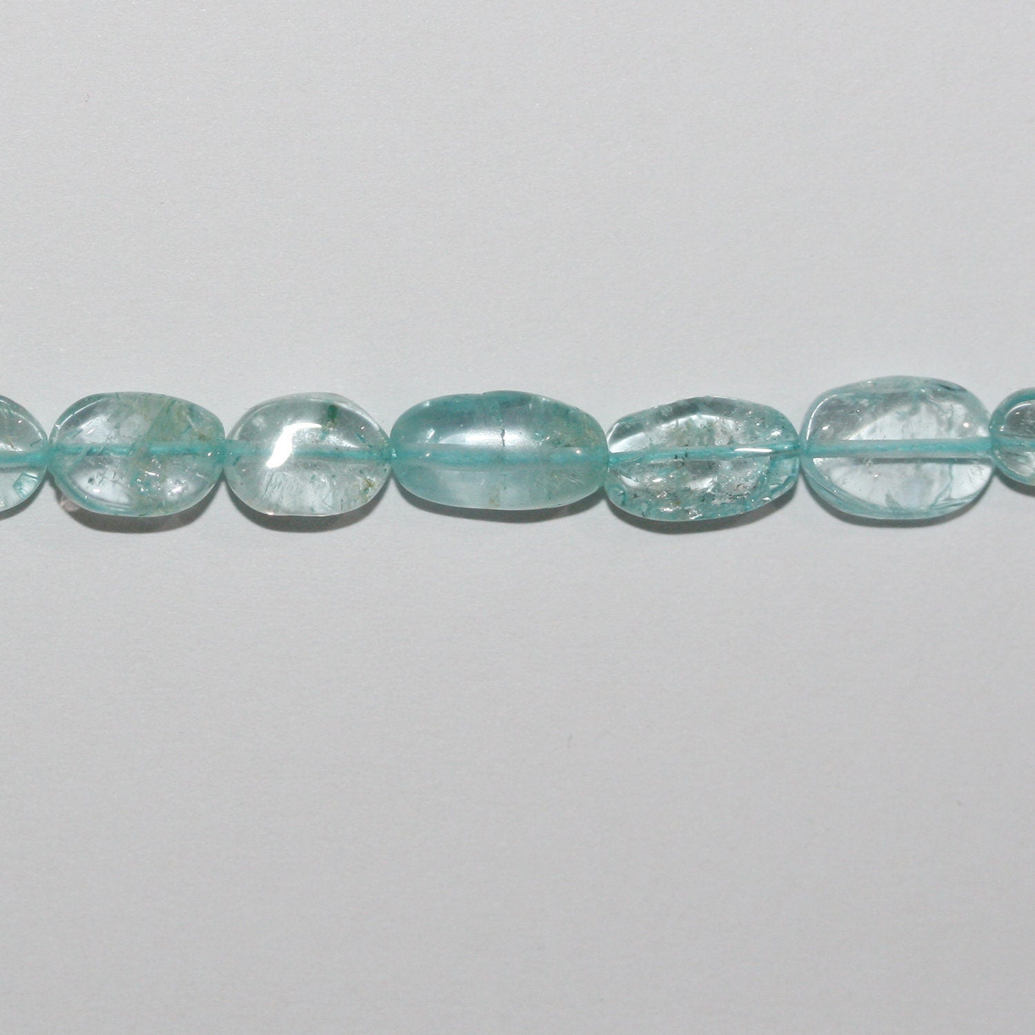 13" St. Aquamarine Smooth Oval Beads 7x5mm. Approx.- Strand 34cm.