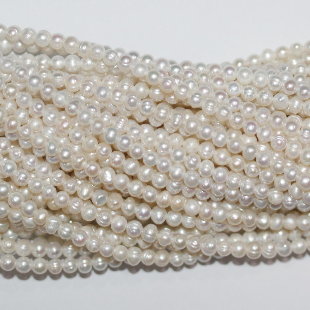 Perla de agua dulce redonda de 14" de St. 3,5-4 mm. - Hilo de 37 cm.