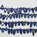 Collier de perles ovales en lapis-lazuli de 15 pouces (environ 39 cm), lisses et irrégulières, de 10 à 18 mm de diamètre. Longueur approximative : 39 cm.