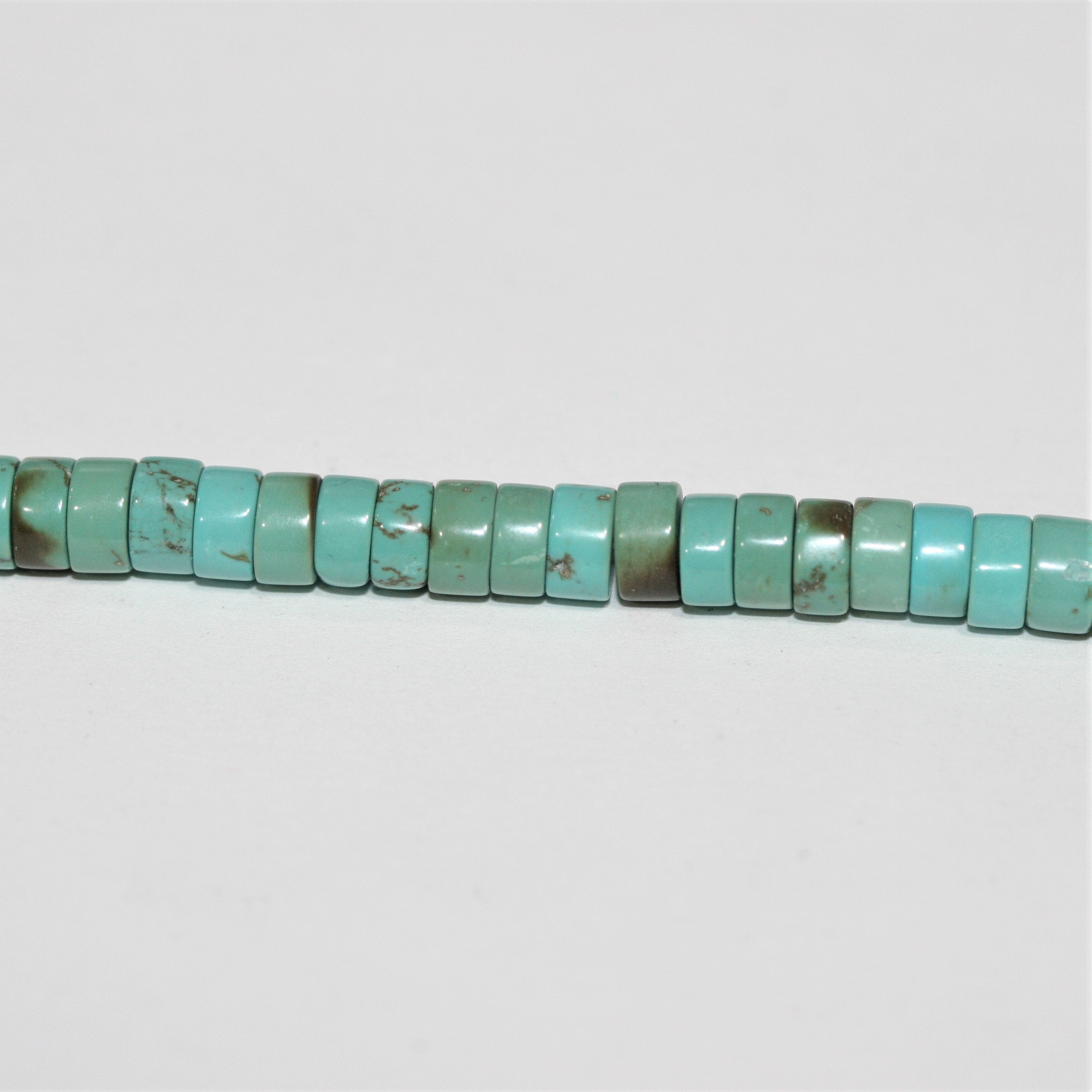 Perles rondelles lisses en turquoise St. 15" 6x3mm.- Brin 39cm.
