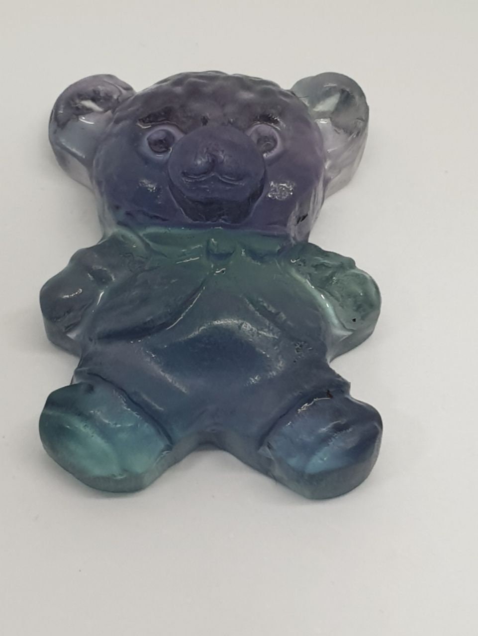 Colgante de fluorita tallada en forma de oso de peluche (26 x 20 mm). Con orificio para el colgante.