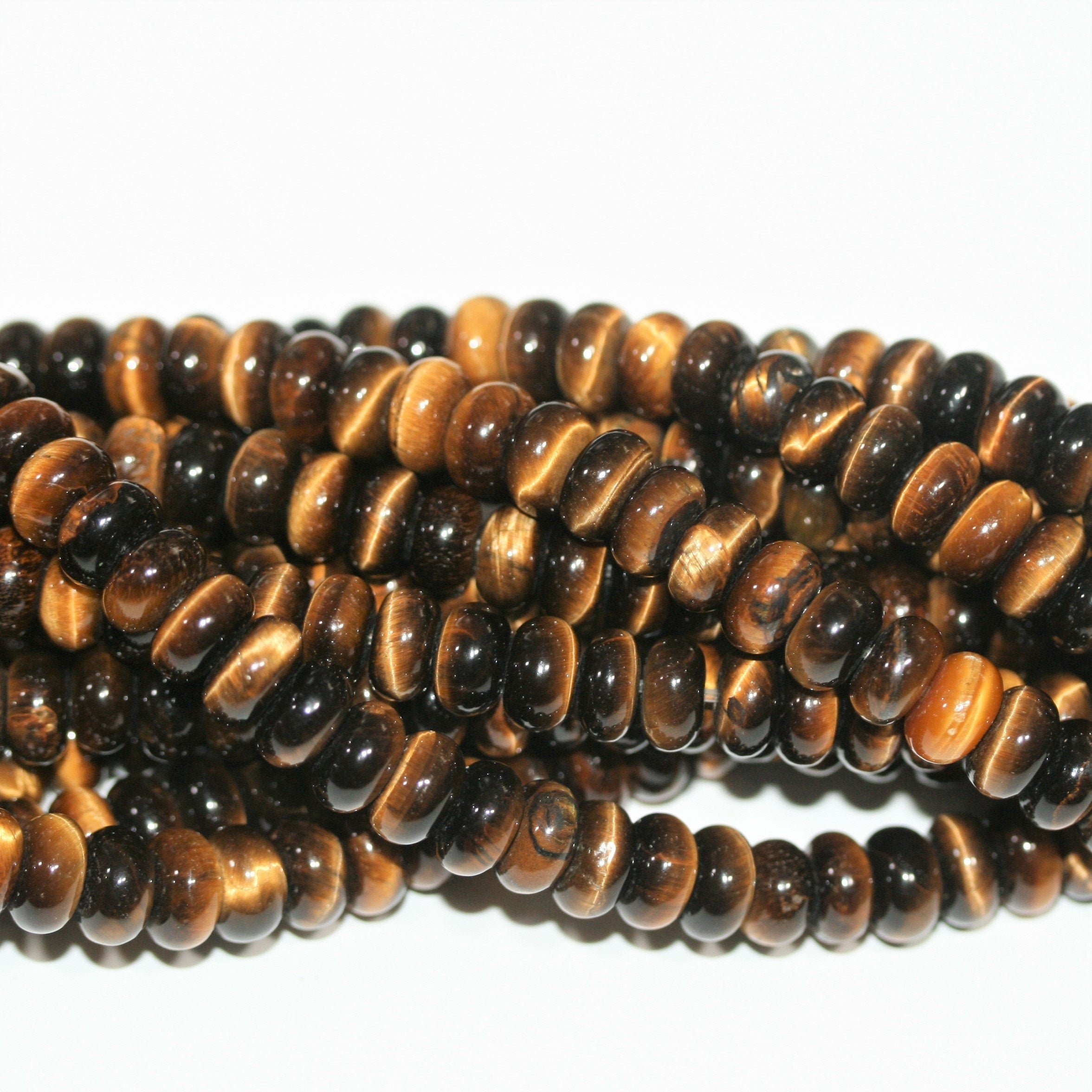 Perles rondelles lisses œil de tigre St 15" 8x4mm.- Brin 38cm.