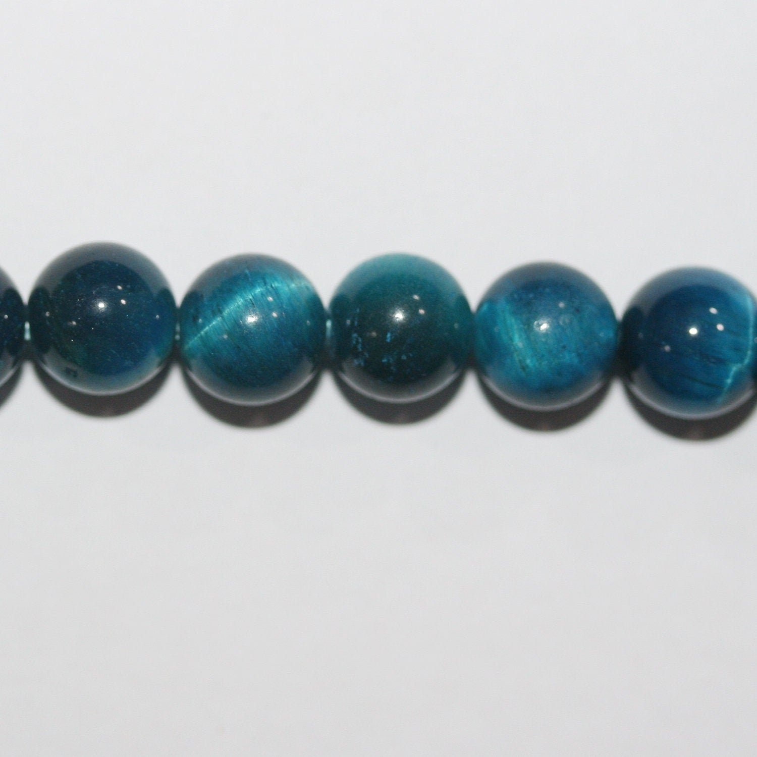 Perles rondes lisses œil de tigre bleu St 15" 8 mm.-Rig 39 cm.