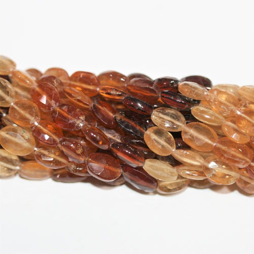 Perles ovales à facettes en grenat St Hesonite 12" (8 x 6 mm). Longueur approximative du fil : 32 cm.