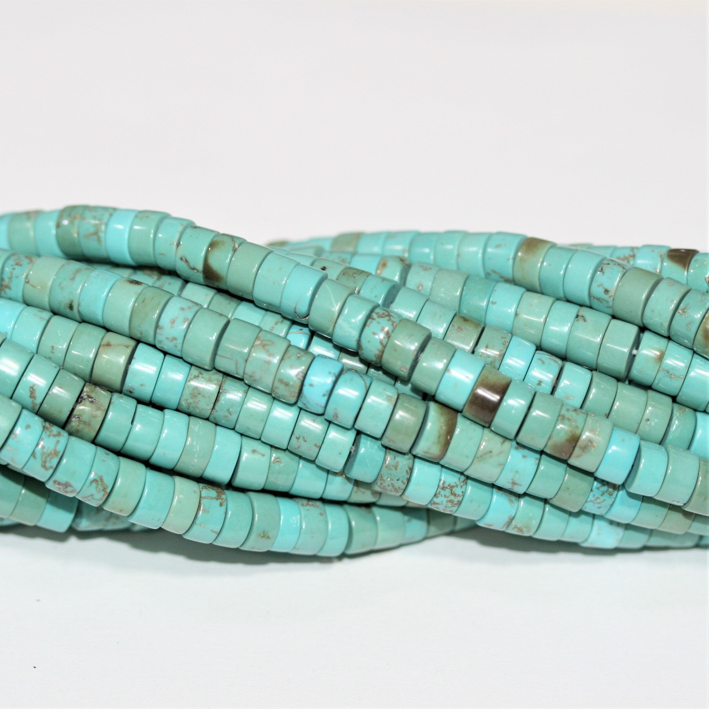 Perles rondelles lisses en turquoise St. 15" 6x3mm.- Brin 39cm.