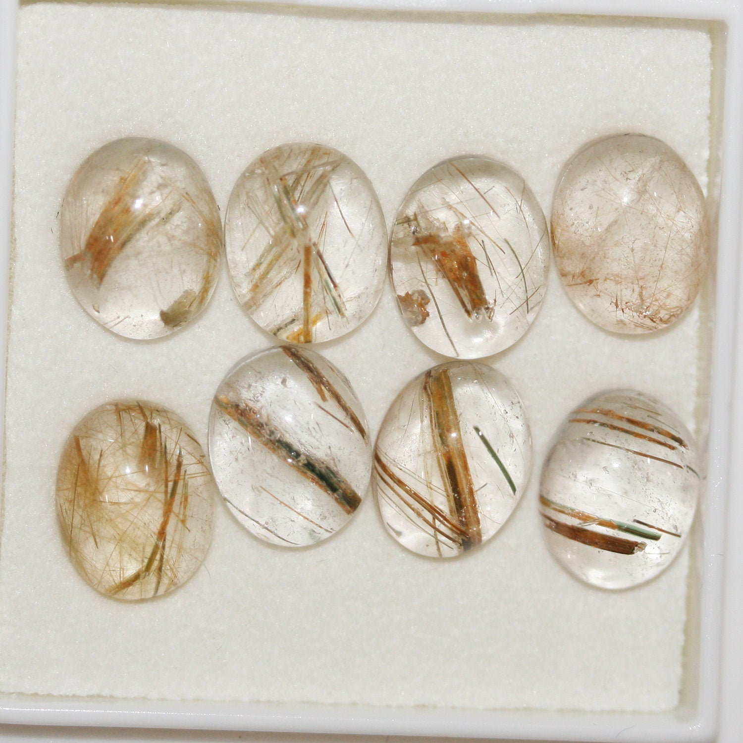 Lote de 8 cabujones ovalados de cuarzo rutilado de 10 x 8 mm. (8 uds.)