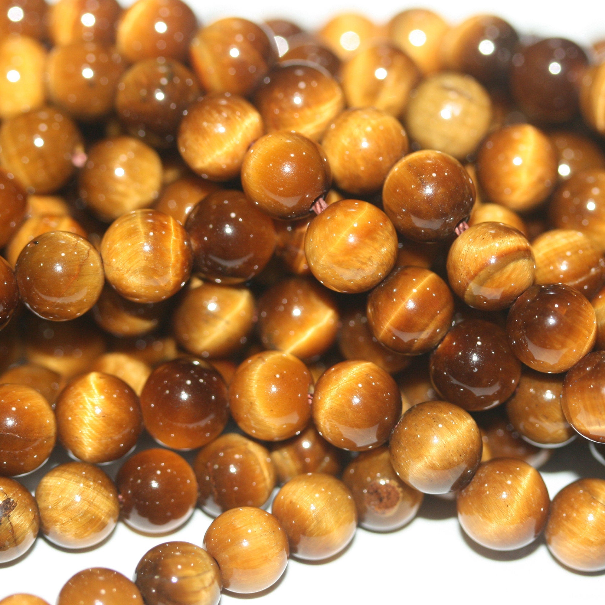 Perles rondes lisses œil de tigre AAA 15" St 10 mm. - Fil 39 cm.