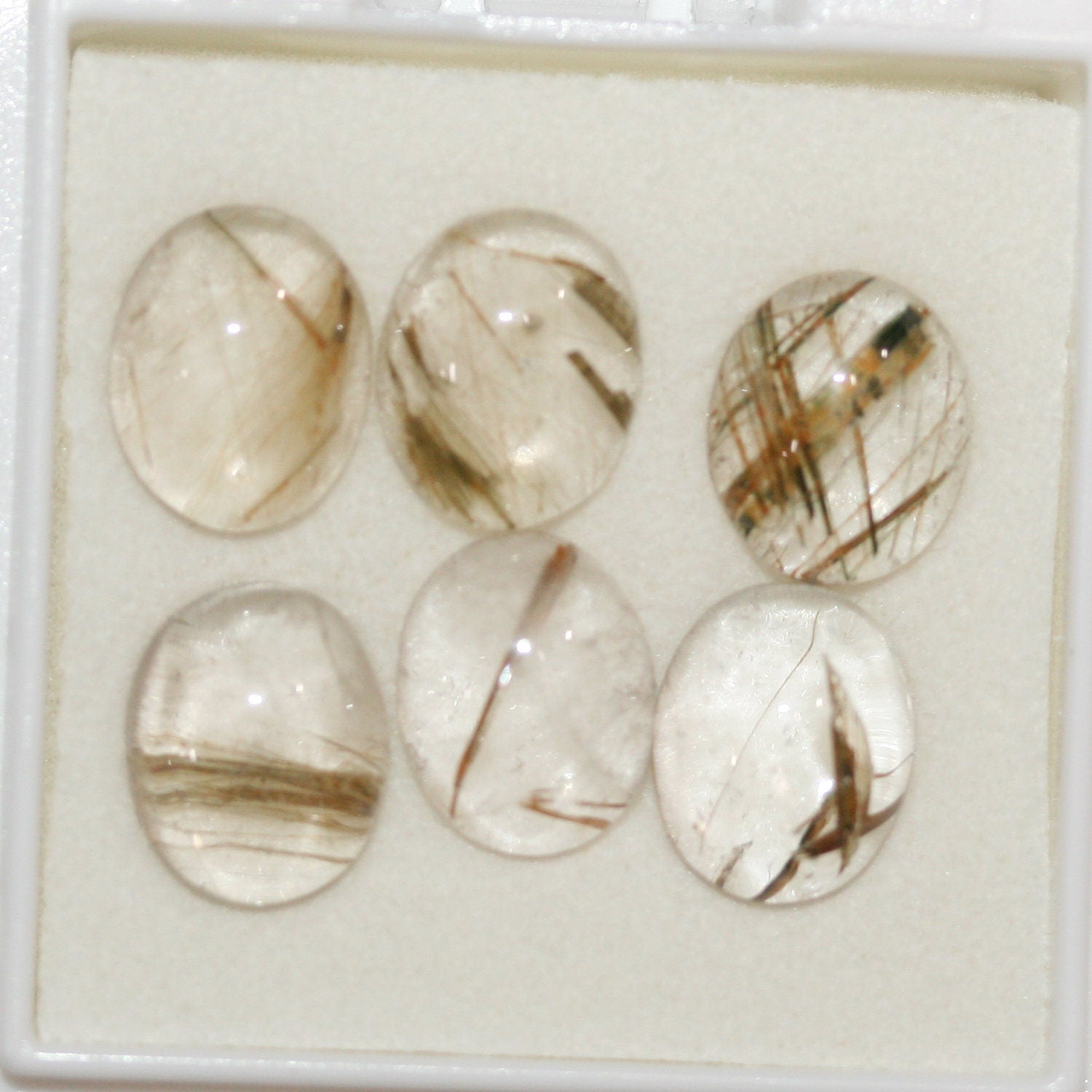 Lote de 6 cabujones ovalados de cuarzo rutilado de 11 x 9 mm. (6 uds.)