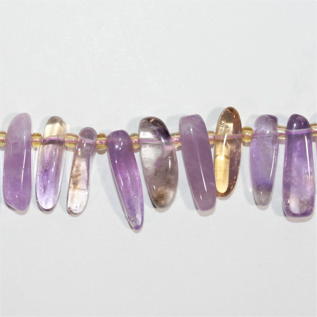 Perles bâtonnets lisses dégradées en Sainte-Amétrine, 15 pouces (11 x 4 à 23 x 8 mm). Longueur approximative du fil : 39 cm.