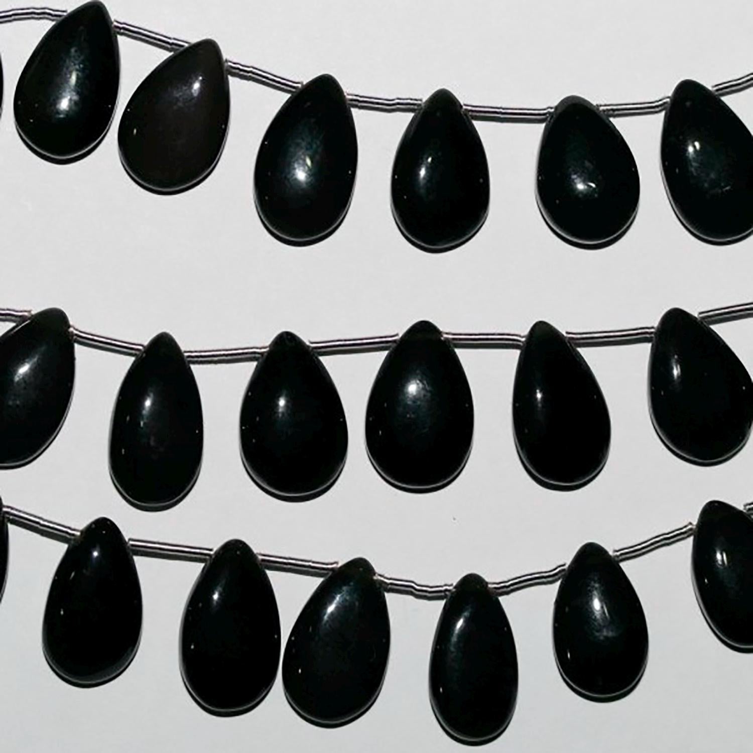 Cuentas lisas de calcedonia negra de 18 cm, 16 x 10 mm (aprox.). Hilo de 18 cm.