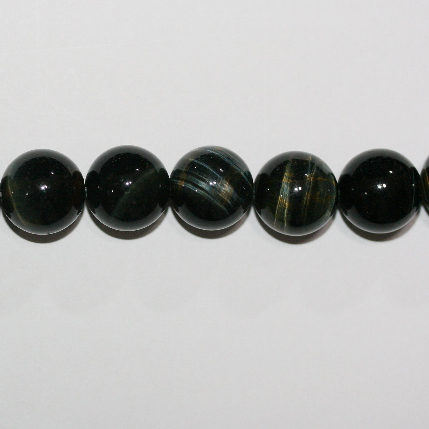 Perles rondes lisses œil de tigre St 15" 14 mm.-Rig 39 cm.