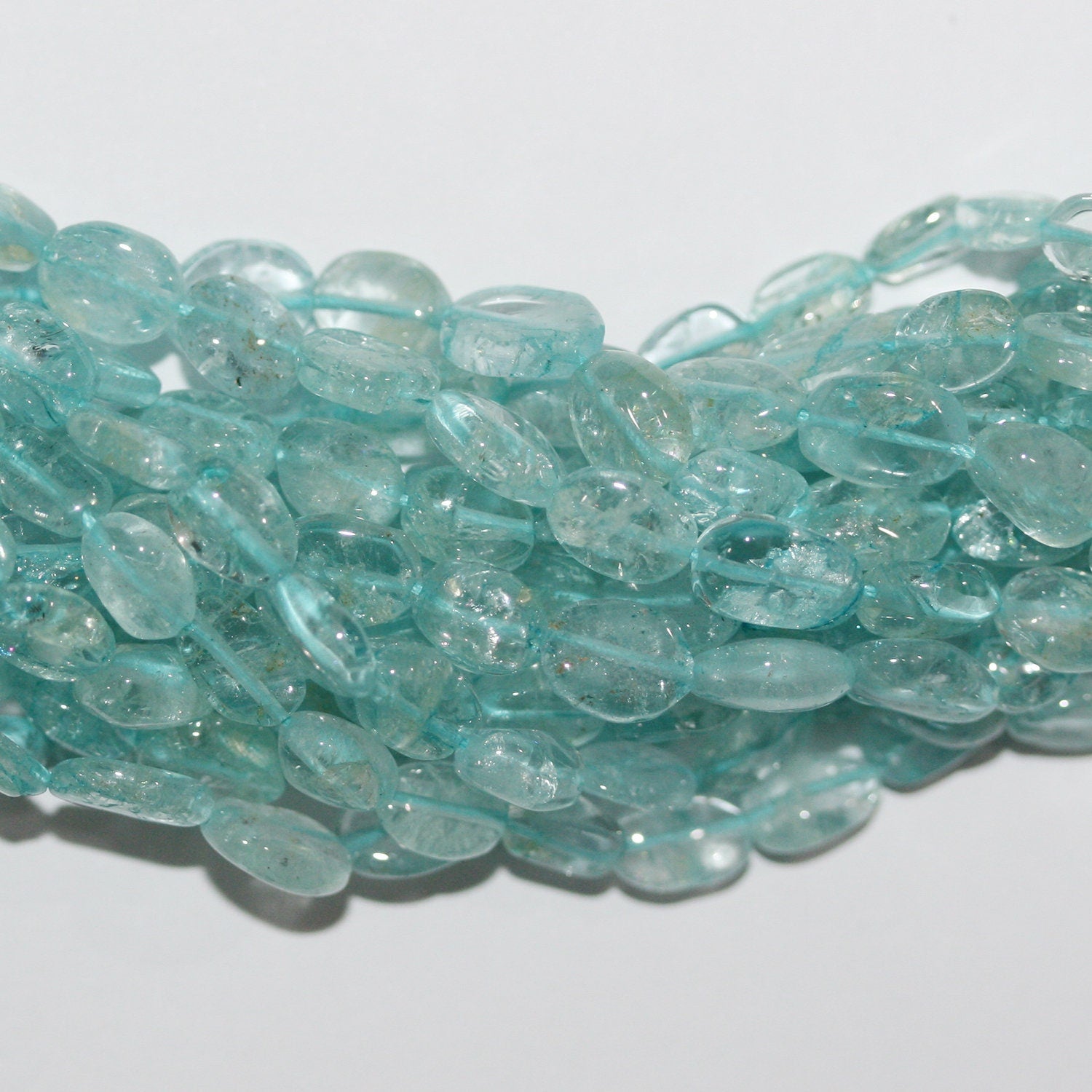 13" St. Aquamarine Smooth Oval Beads 7x5mm. Approx.- Strand 34cm.