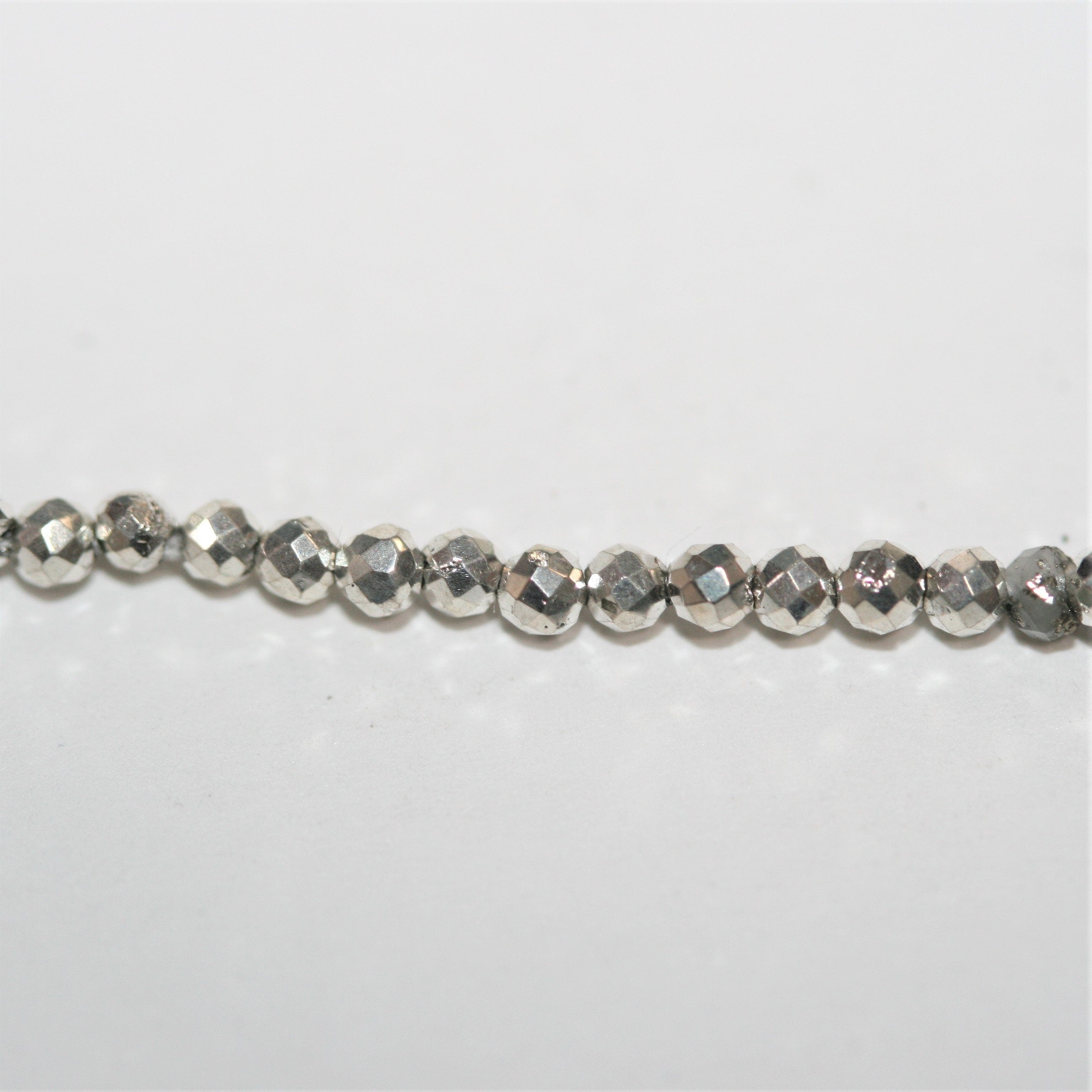 13" St. Silver Pyrite Faceted Round Beads 2mm.- Strand 34cm.