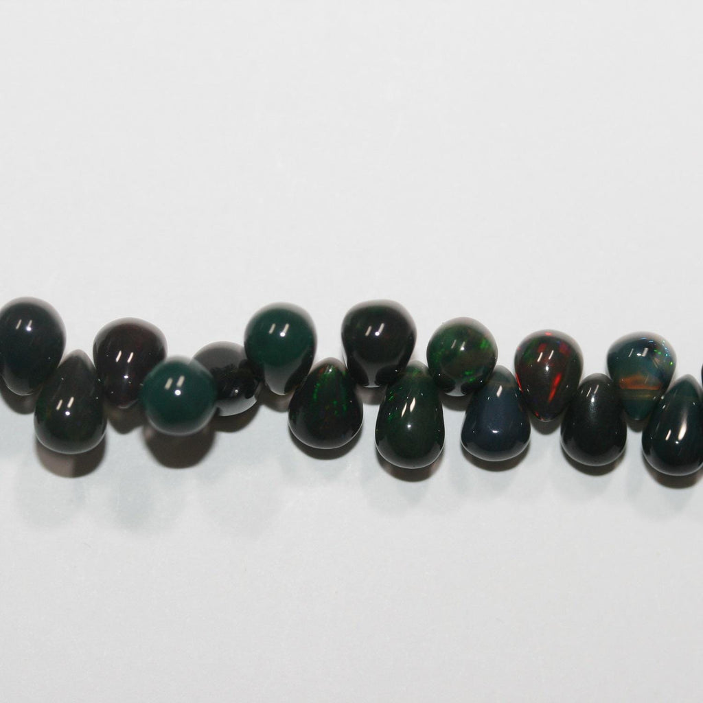 Cuentas de ópalo etíope negro de 8" con efecto degradado suave. 8 x 5 mm - 5 x 3,5 mm. Hilo de 20 cm. Ref. 14883