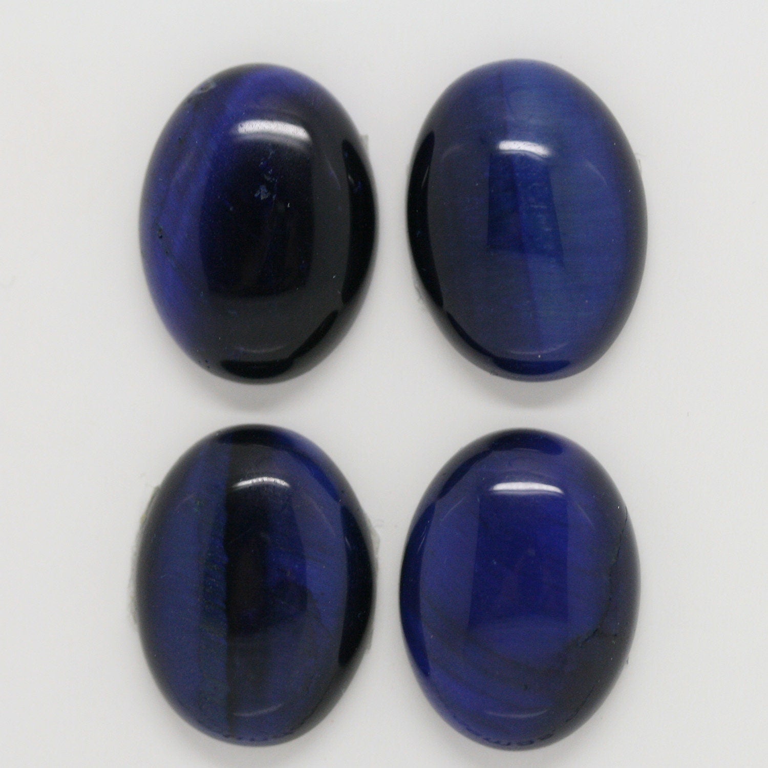 Lote de 4 cabujones ovalados de ojo de tigre azul de 20 x 15 mm. (4 uds.)