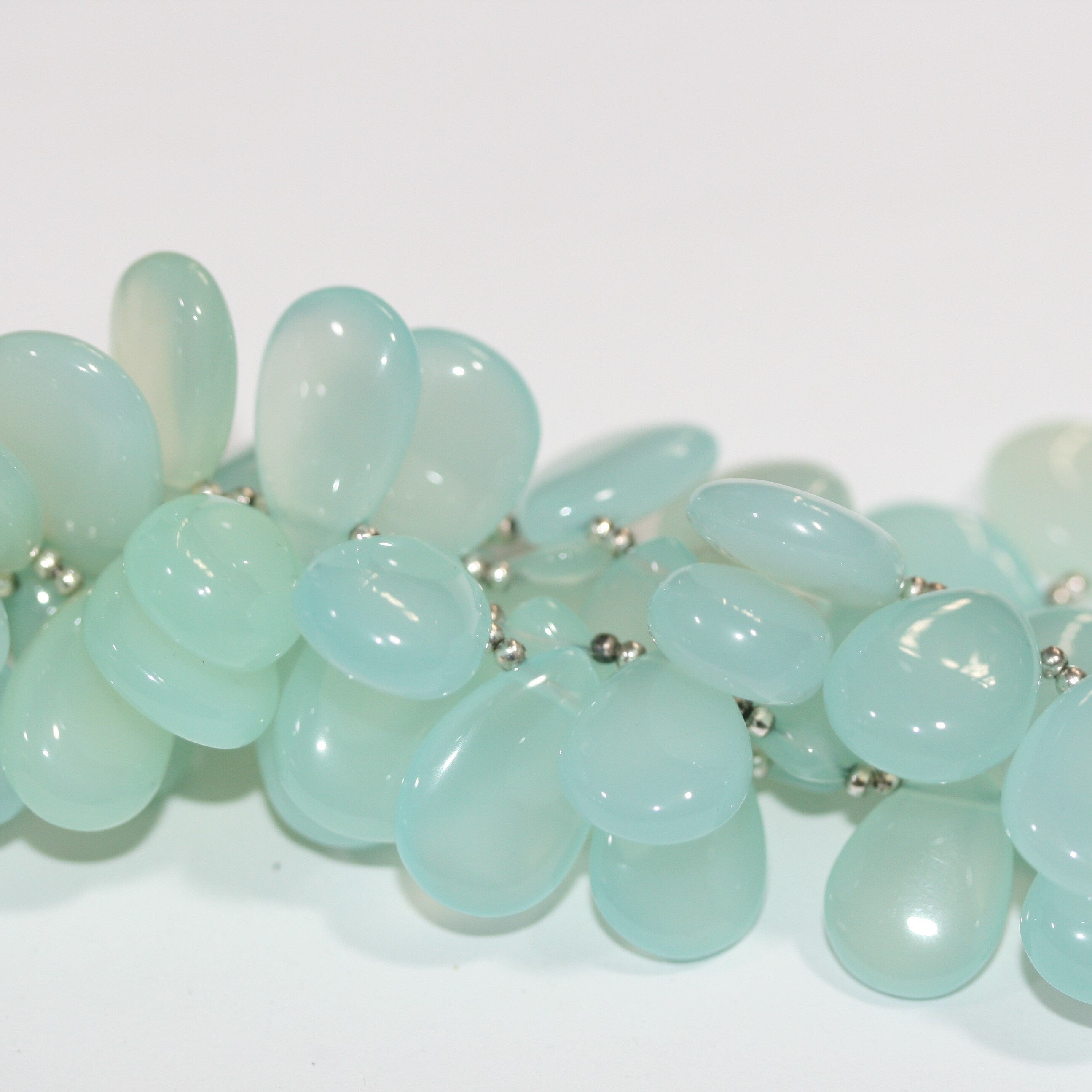 Perles en calcédoine bleu-vert lisses en forme de goutte, 20 x 13 mm. Longueur du fil : environ 22 cm.