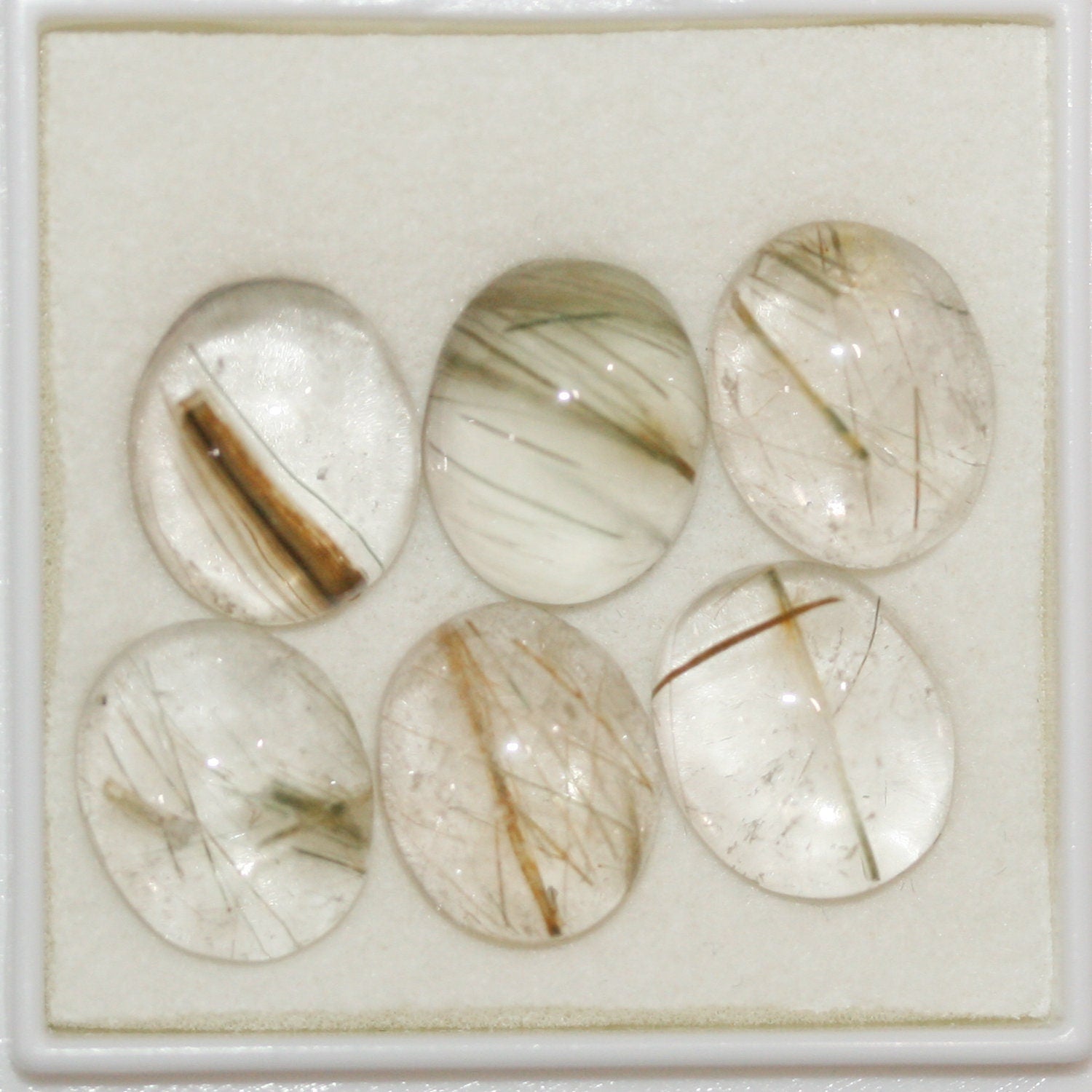 Lote de 6 cabujones ovalados de cuarzo rutilado de 12 x 10 mm. (6 uds.)