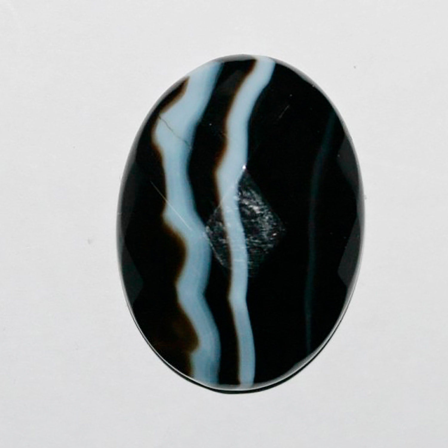 Lote de 2 cabujones ovalados facetados de ónix blanco rayado de 30 x 22 mm. (2 unidades)