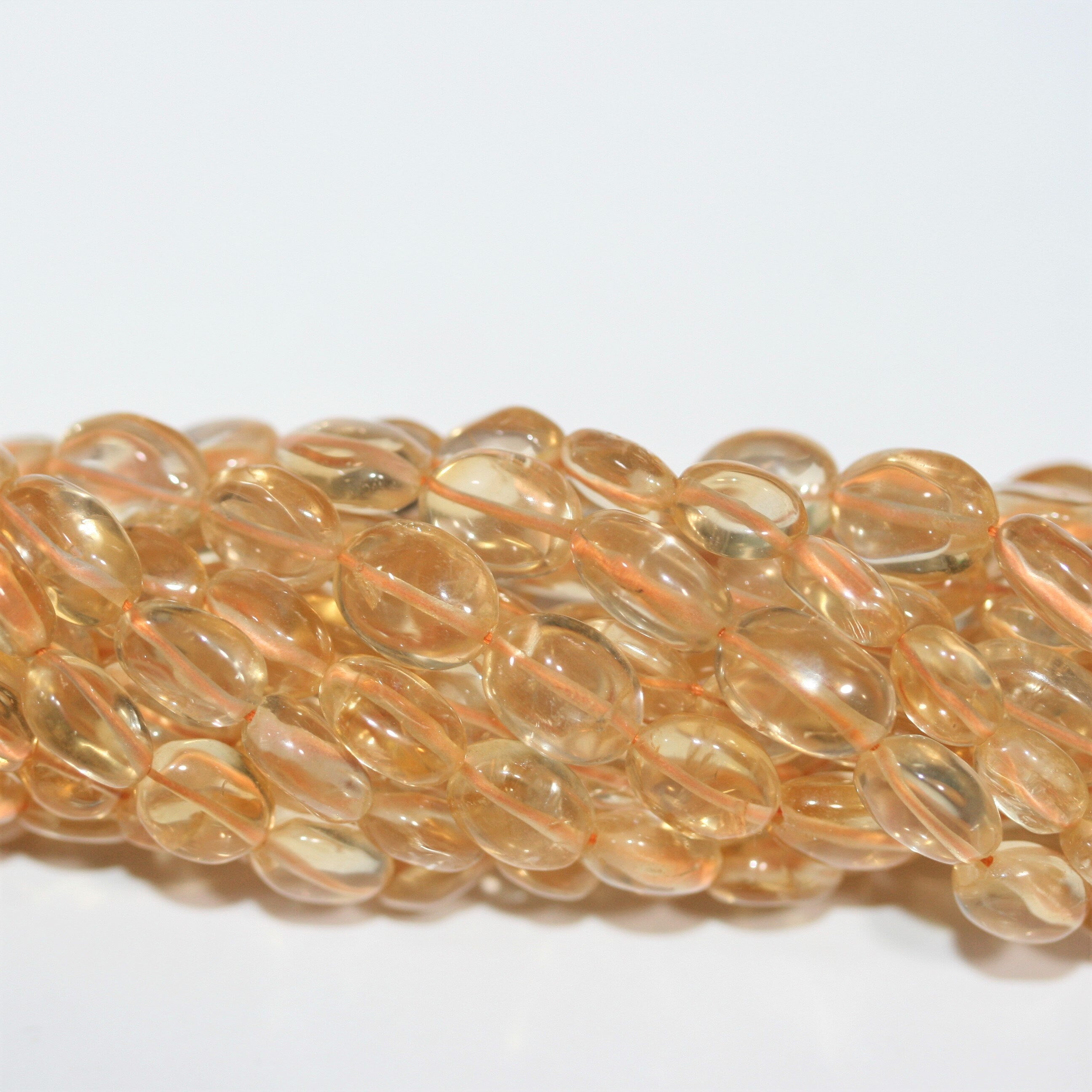 Perles ovales lisses de citrine 10x8mm environ - Fil de 37cm.