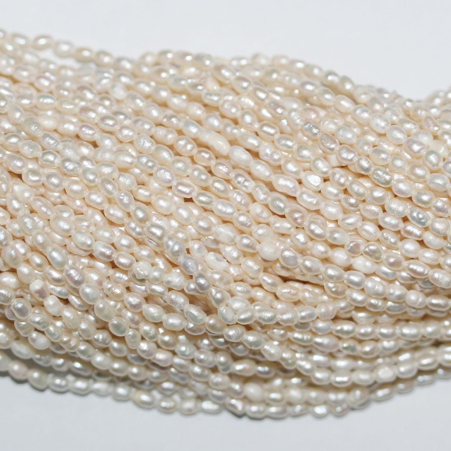 Perla de agua dulce ovalada de 14" (2-2,5 mm) - Hilo de 37 cm - Precios al por mayor de perlas naturales