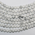 Perles rondes lisses en howlite blanche St 14" 8 mm - Percées à 2,50 mm - Fil de 36 cm.