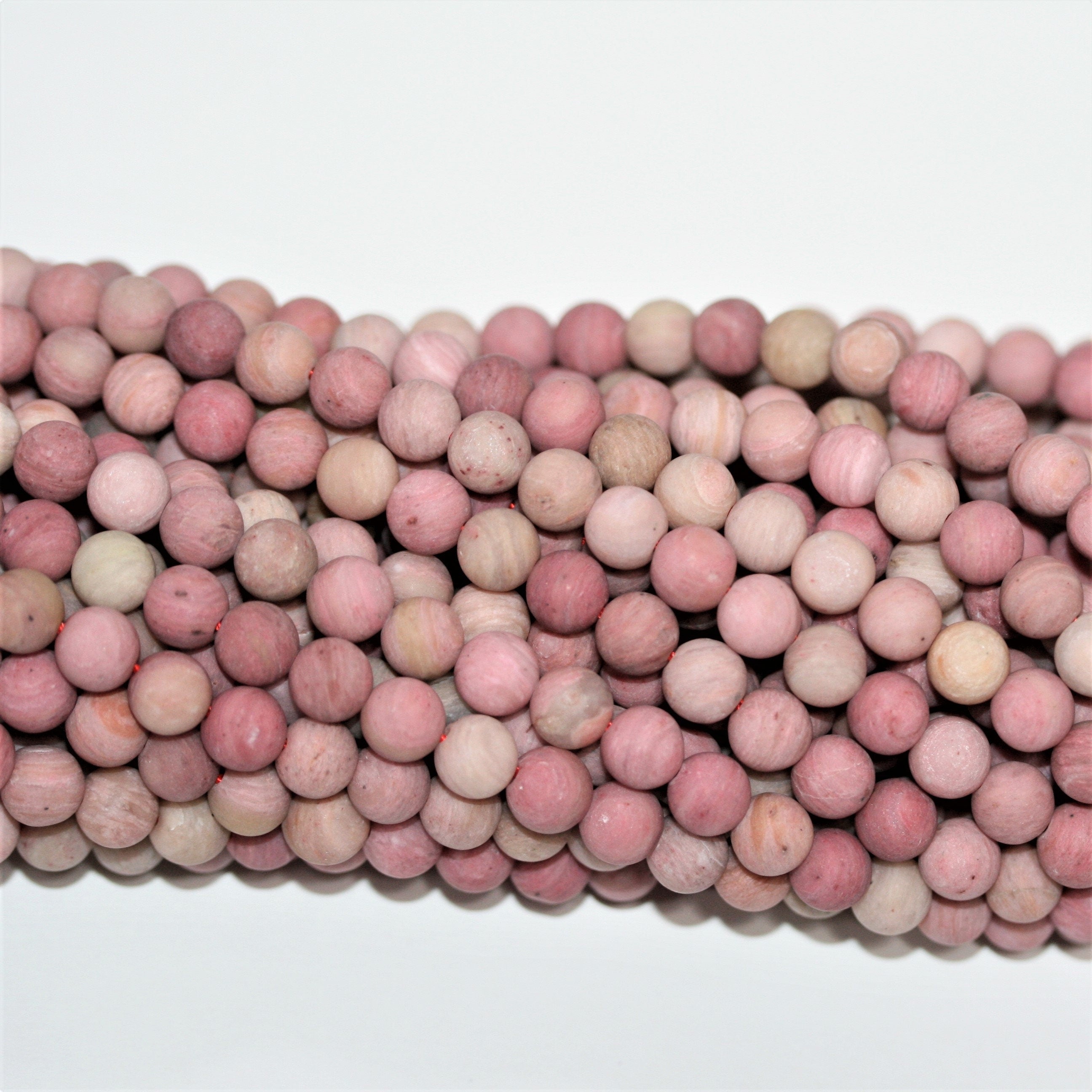 Perles rondes lisses en rhodonite mate 6 mm - Fil de 39 cm.