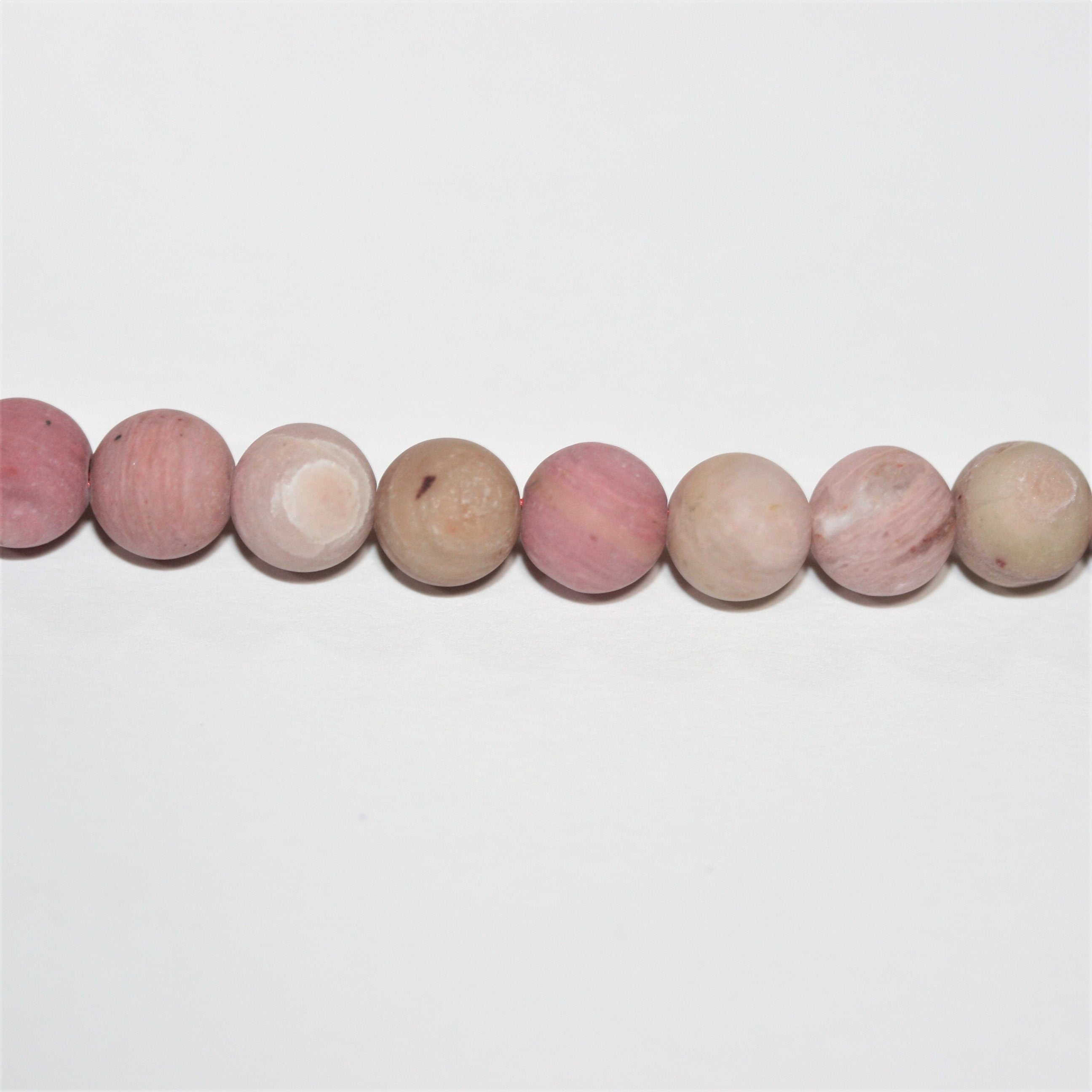 Perles rondes lisses en rhodonite mate 6 mm - Fil de 39 cm.