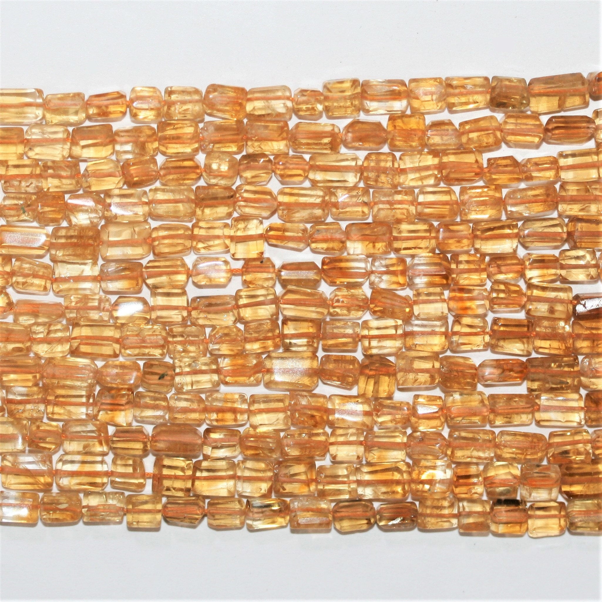 15" Perles de citrine facettées prismatiques 7x5mm.- Brin 38cm.