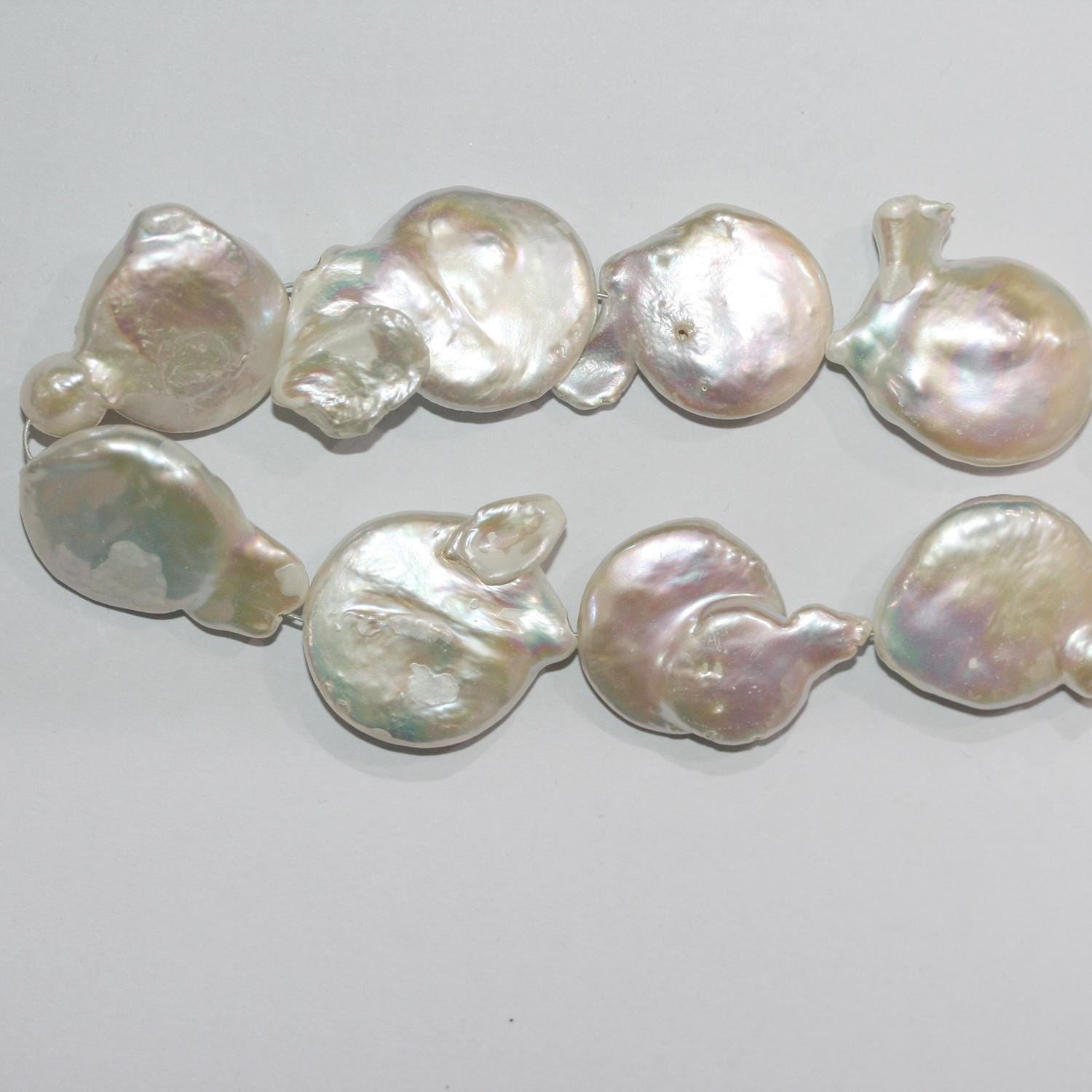 Perla de agua dulce irregular de 14" (19-21 mm). Tira de 37 cm. Precios al por mayor.