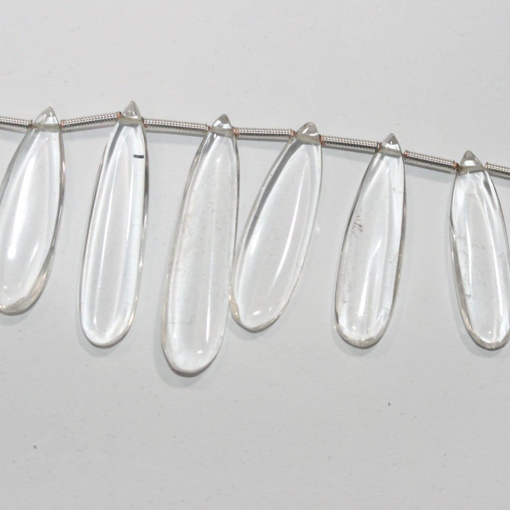 Perles plates lisses en cristal de roche de 20 cm (8 pouces), 37 x 9,5 à 22,7 x 8 mm, longueur 20 cm. Réf. 14995