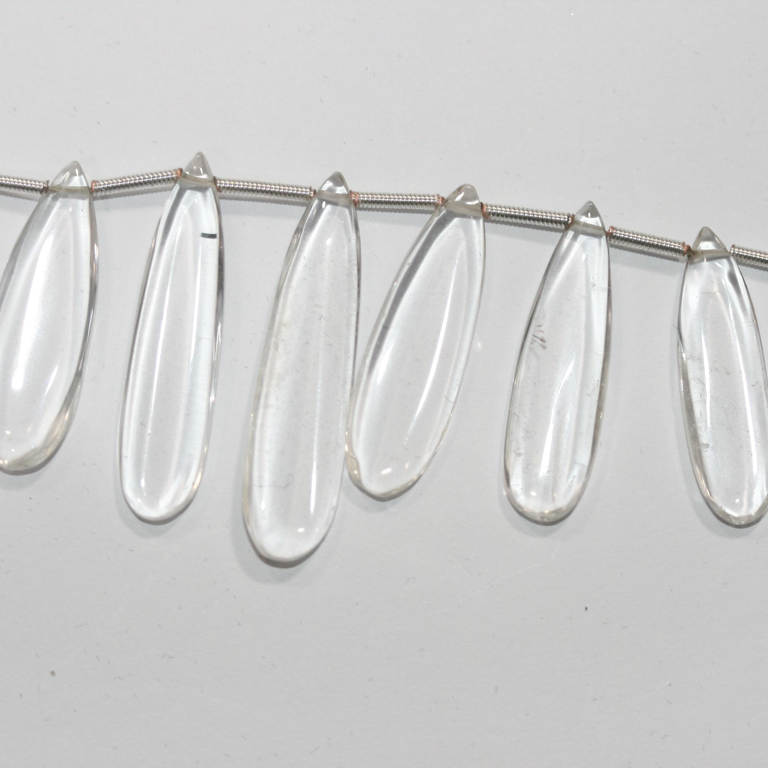 Perles plates lisses en cristal de roche de 20 cm (8 pouces), 37 x 9,5 à 22,7 x 8 mm, longueur 20 cm. Réf. 14995