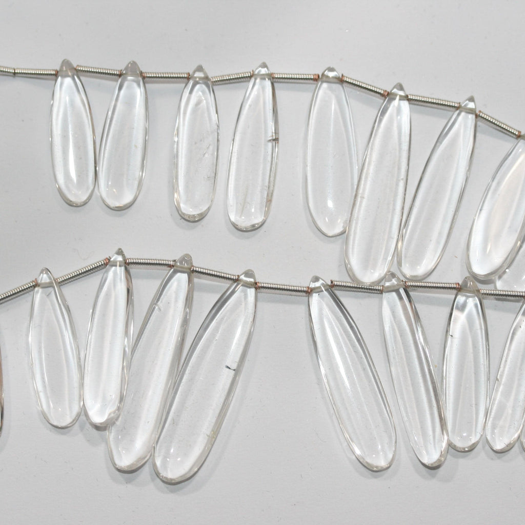 Perles plates lisses en cristal de roche de 20 cm (8 pouces), 37 x 9,5 à 22,7 x 8 mm, longueur 20 cm. Réf. 14995