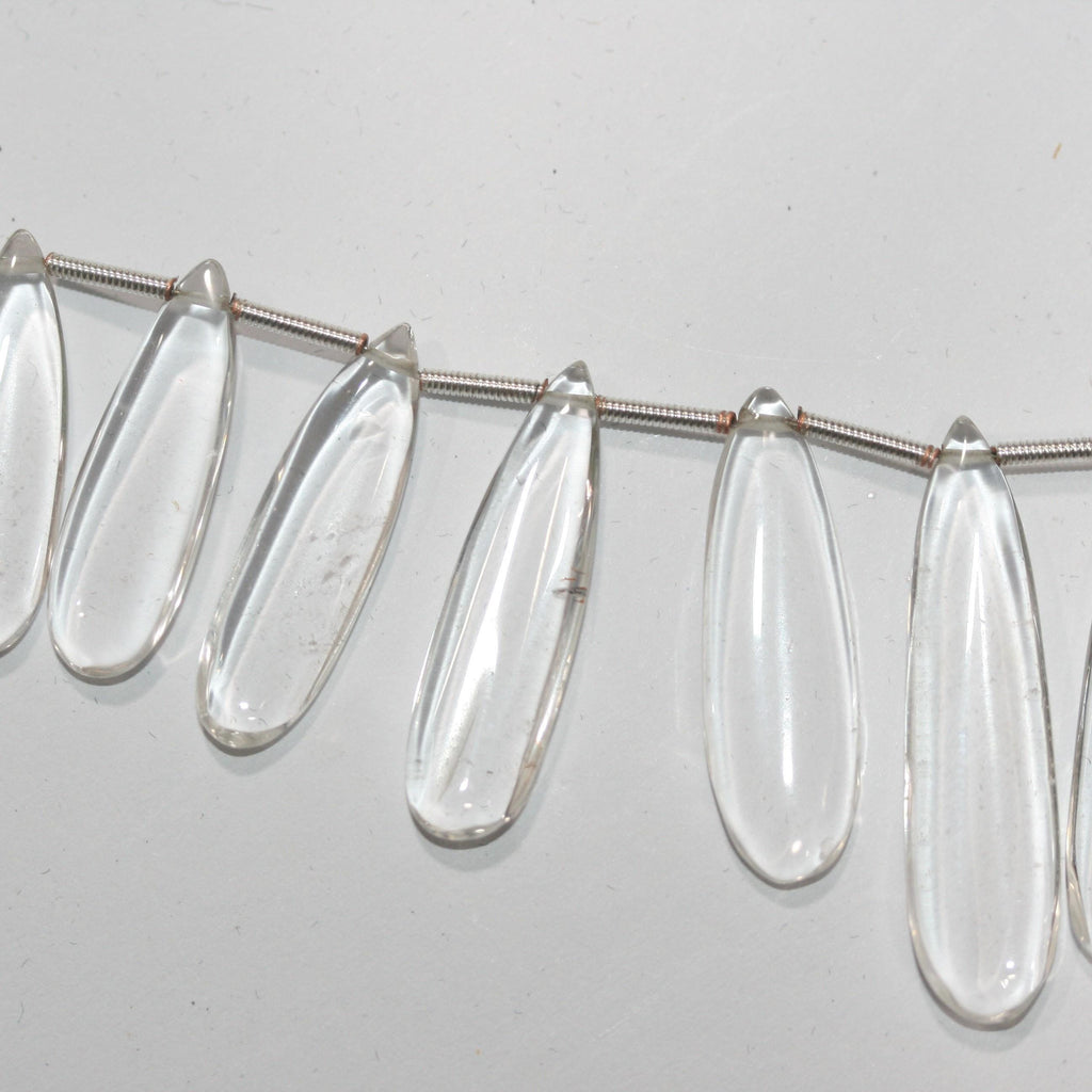 Perles plates lisses en cristal de roche de 20 cm (8 pouces), 37 x 9,5 à 22,7 x 8 mm, longueur 20 cm. Réf. 14995